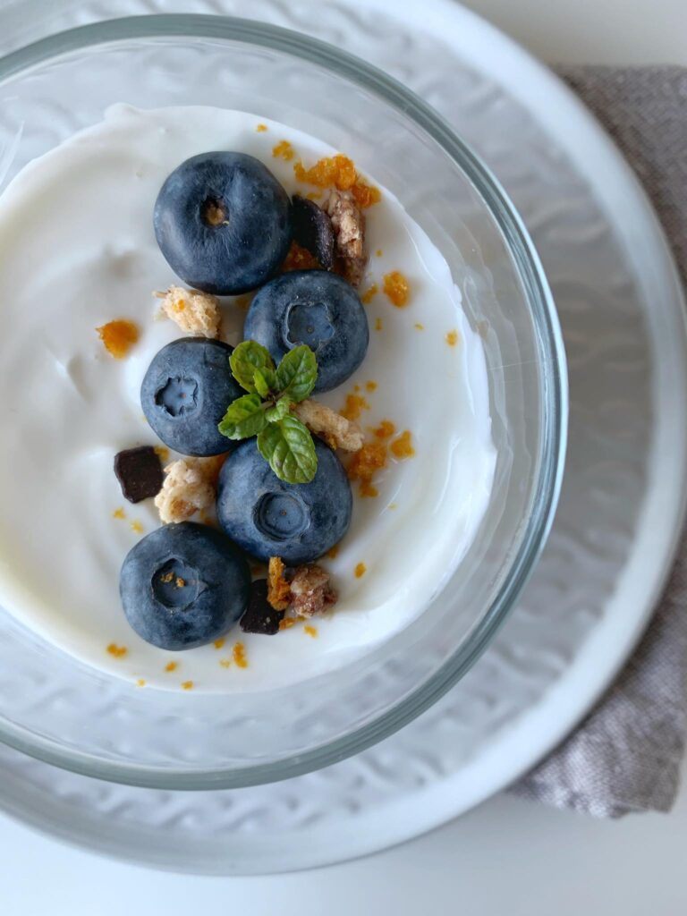 yogurt greco alla vaniglia con granola , frutta e polvere d'arancia
